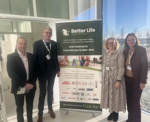 Savic representatives at the launch of Better Life for Pets & People in Belgium, standing next to the BLPP banner with partner logos